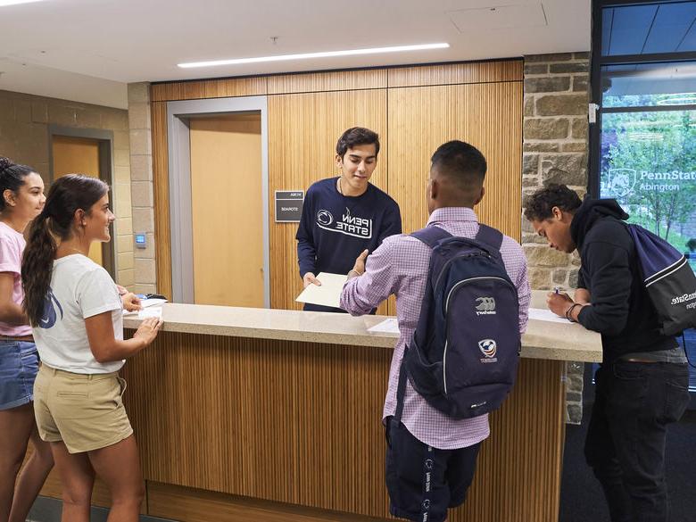 Students at front desk of lions gate